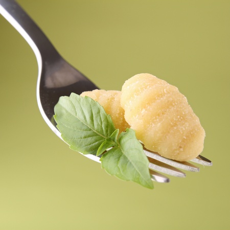 fork with gnocchi and basilの写真素材