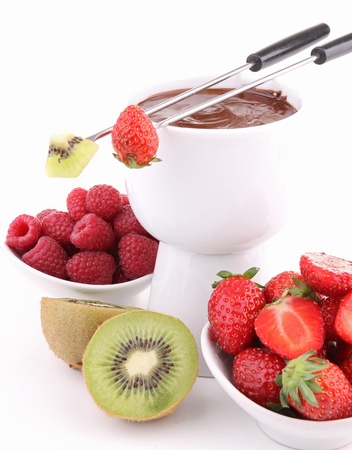 isolated chocolate fondue with fruits on whiteの写真素材