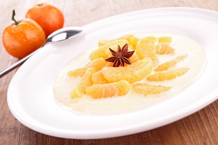 vanilla cream with slice of tangerineの写真素材