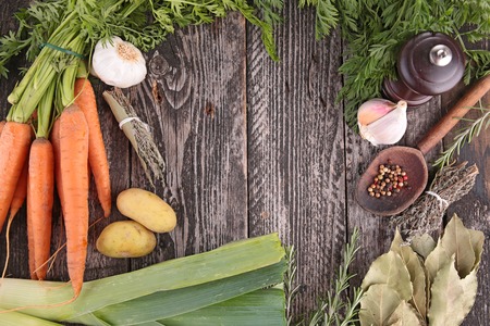 raw vegetables and spices on woodの写真素材