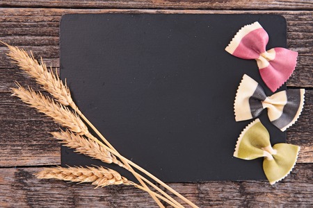black board with wheat and pastaの写真素材