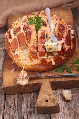 bread cooked with cheese, bacon and parsleyの写真素材