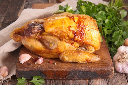 baked chicken on chopping boardの写真素材