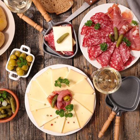 raclette party with cheese and baconの写真素材