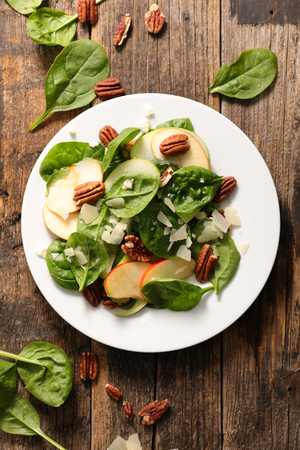 spinach salad with apple,cheese and pecan nutの写真素材