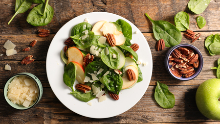 spinach salad with apple,cheese and pecan nutの写真素材