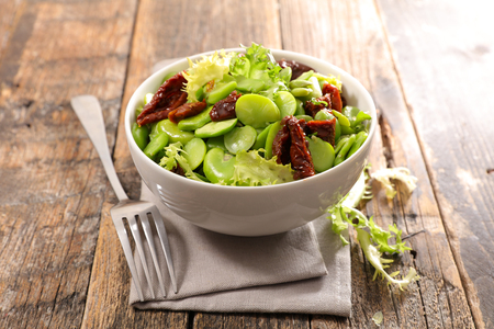 broad bean salad on wood backgroundの写真素材