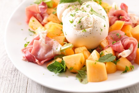 melon salad with prosciutto ham and mozzarellaの写真素材