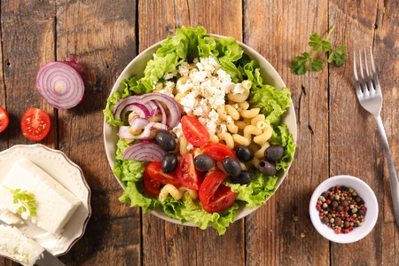 mixed salad with pasta, tomato, olive and cheeseの写真素材