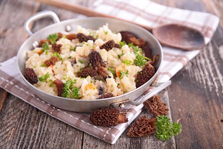 mushroom risotto and herbs in panの写真素材