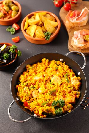 spanish food with paella, tapas and patatas bravasの写真素材