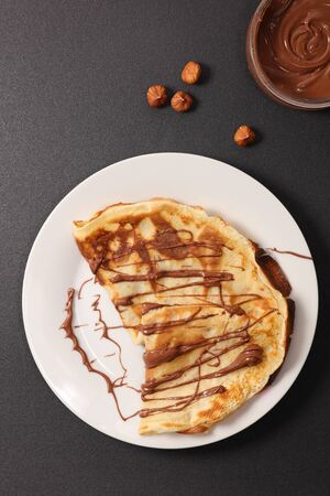 crepe with chocolate sauce in plate