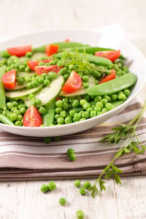 vegetable salad with pea, green bean, cucumber and tomatoの写真素材