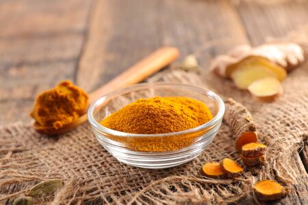 curcuma spice root on wood backgroundの写真素材