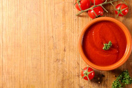 tomato sauce and herbs on wood backgroundの写真素材