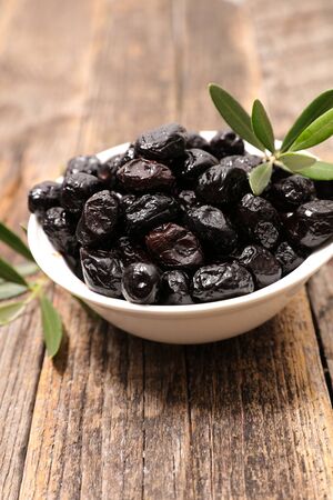 bowl of black olive and leafの写真素材