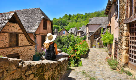 woman touriston the street-travel to Europe, village of Conques