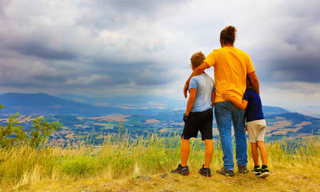 family- father with children looking at Auvergne landscape in Franceの写真素材