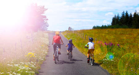 happy family bicycling in countryside in France- Family on cycyle ride