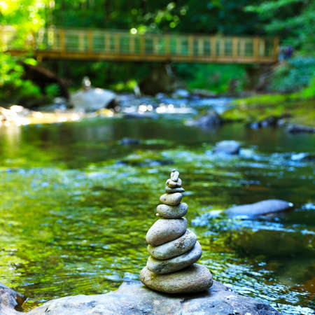 stone zen, river and suspended wooden brige background