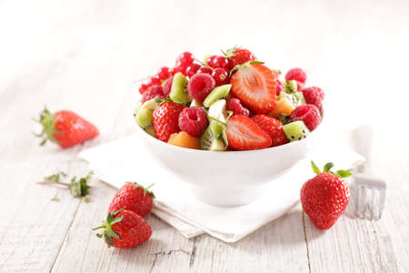 fresh fruit salad in bowl with berry fruitの写真素材