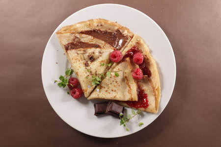 crepe with chocolate and berry fruit jamの写真素材