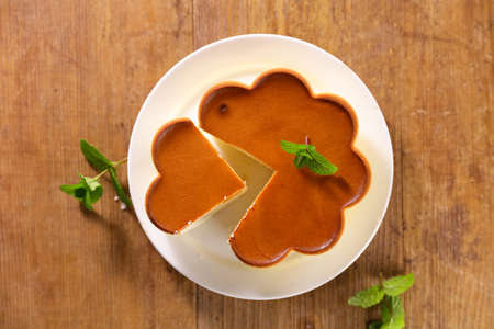 cheesecake and slice on wood background