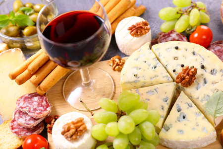 red wine glasses with cheeseの写真素材