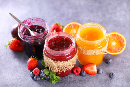 assortment of jams and fresh fruitsの写真素材