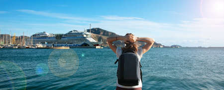 woman looking at sea and cruise ship