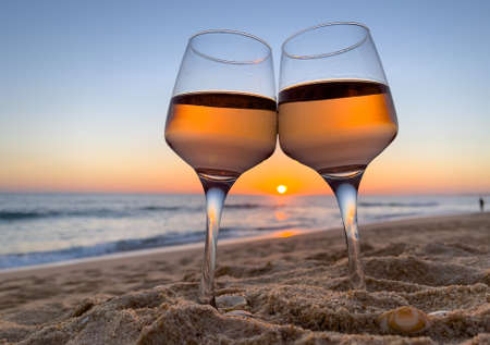 red wine glasses on the beachの写真素材