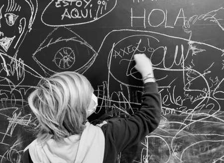child with mask face and blackboardの写真素材