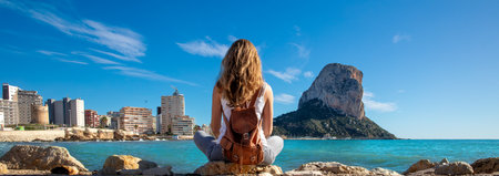 Woman looking at Calpe rock and mediterranean sea in Spainの写真素材
