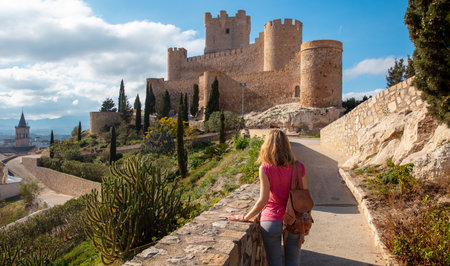 Woman tourist enjoying beautiful view of Villena castle, Alicante in Spainの写真素材