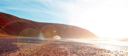 Sunset at red arches of Legzira beach, Sidi Ifni in Moroccoの写真素材