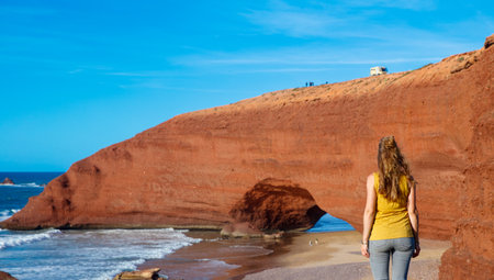 Red natural arch and atlantic ocean- tour tourism in Moroccoの写真素材