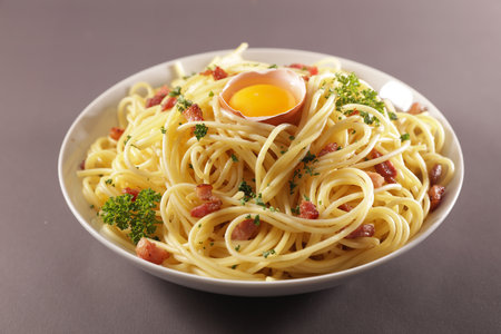bowl of tagliatelle with egg and baconの写真素材