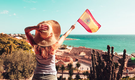 tourism at Tarragona- Woman with spanish flag enjoying beauty amphitheater- Cataloniaの写真素材