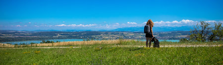 Woman and dog looking at panoramic view in France