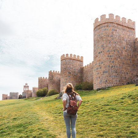 Woman tourist enjoying view of Avila surrounding wall in Spain- Castile and Leonの写真素材
