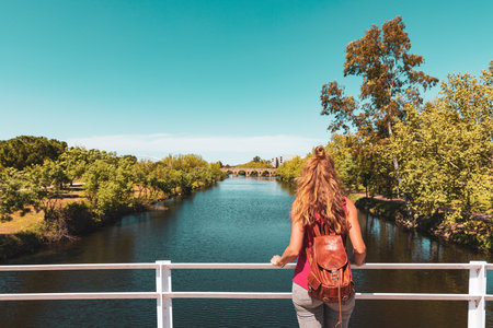 Woman looking at roman bridge in Merida- Spainの写真素材
