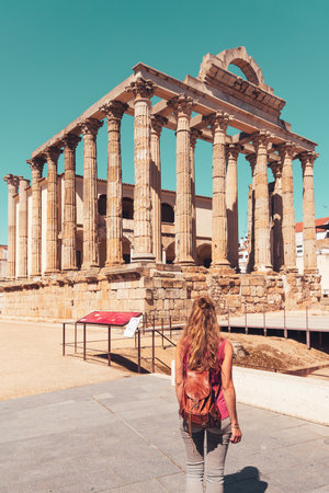 Woman holiday maker admiring the roman temple of Diana in Merida, Spainの写真素材