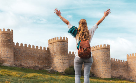Woman tourist enjoying view of Avila surrounding wall in Spain- Castile and Leonの写真素材