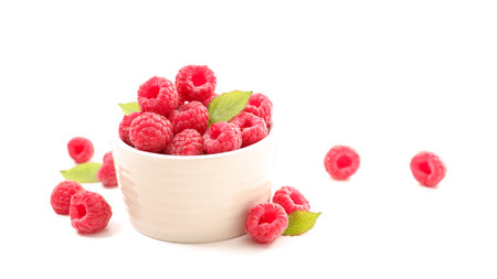 bowl of raspberries fruit isolated on white background