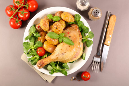 grilled chicken leg with roasted potatoesの写真素材