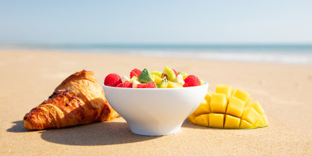 breakfast on the beach- relaxing, vacation, healthy breakfast with fruit salad and croissantの写真素材