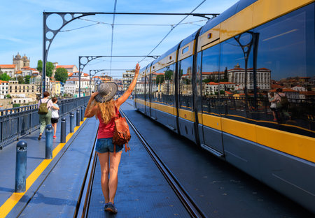 Woman waiting for tram- Porto city in Portugal- travel, tourism, vacation conceptのeditorial素材