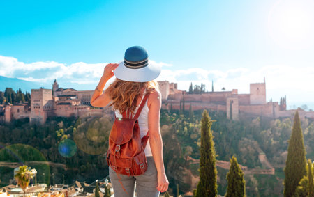 Woman tourist looking at Ancient arabic fortress Alhambra- Granada in Spainの写真素材