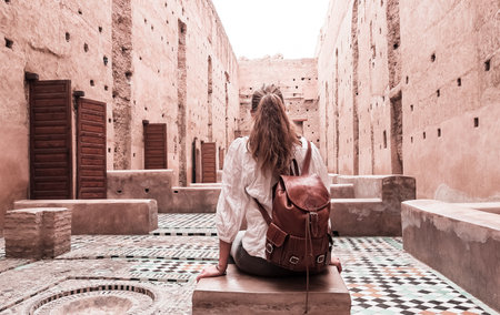 Woman tourist visiting old ruin palace (Palais El Badi) in Marrakech, Moroccoの写真素材