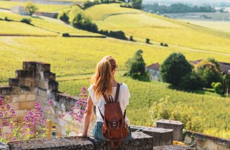 Woman looking at green vineyard, Bordeaux in France